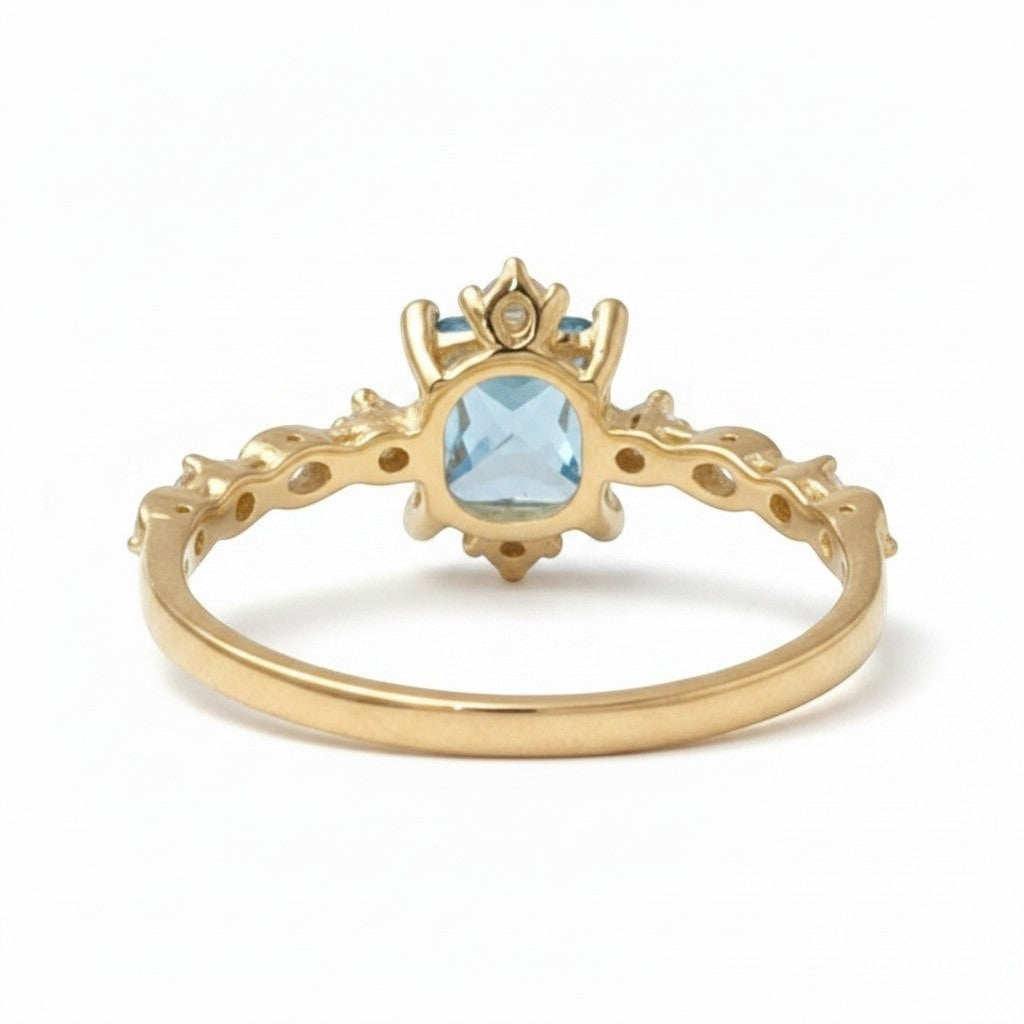 Jade18k yellow gold ring with a square-cut blue gemstone and accent stones on a detailed band.