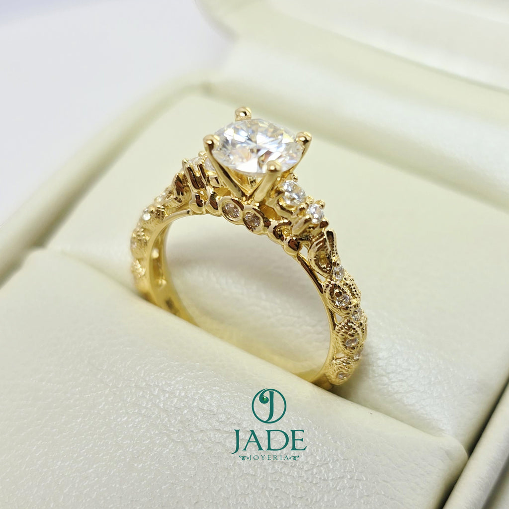 Jade18k Camila engagement ring in 18k orange gold with a central cubic zirconia and intricate detailing on the band.