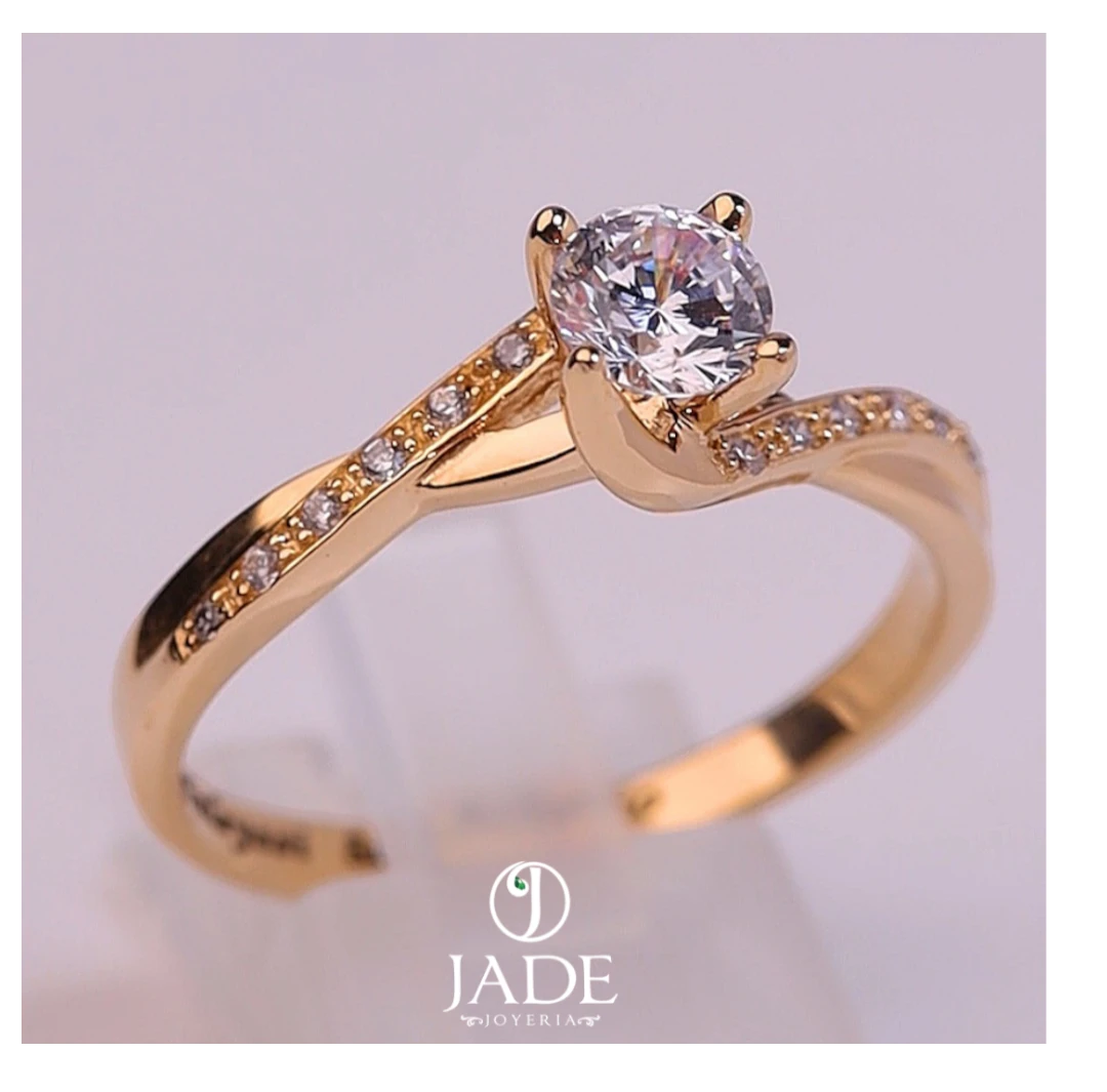 Jade18k Paulina engagement ring in 18k orange gold with a central cubic zirconia and small stones along the band.
