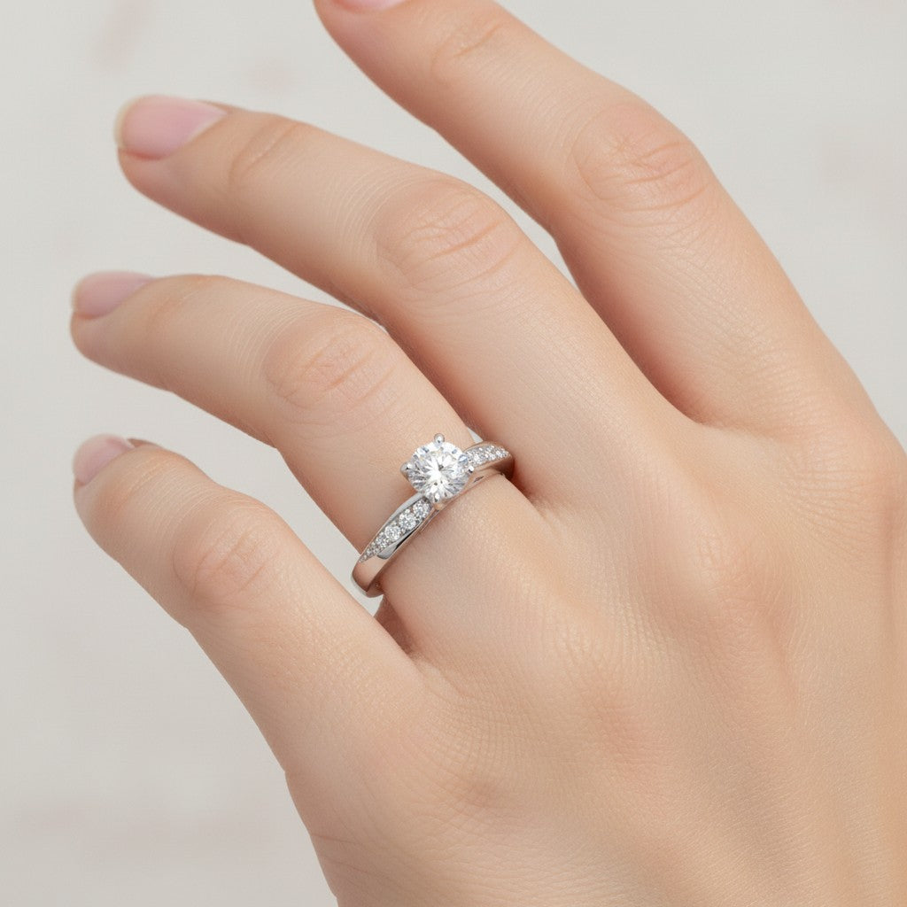 Jade18k April engagement ring in sterling silver with a round-cut diamond and pave side stones.