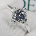 Jade18k Damelia engagement ring with a large central diamond surrounded by smaller diamonds in a silver band.