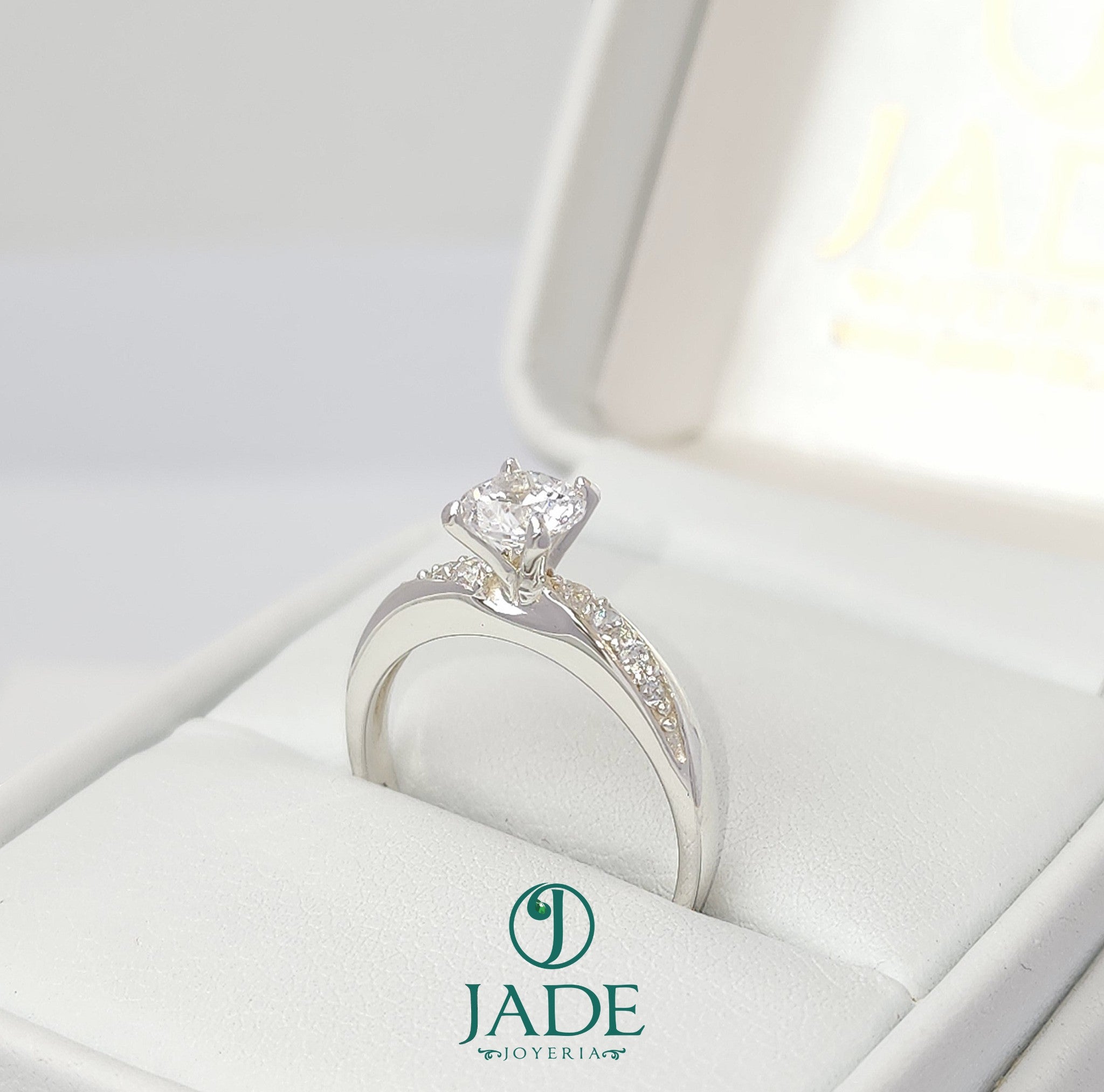 Jade18k April engagement ring in sterling silver with a central diamond and pave side stones.