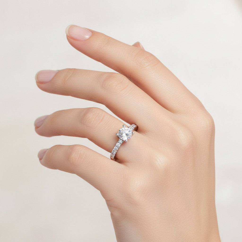 Jade18k Rafaella engagement ring with a round brilliant cut diamond and pavé band in sterling silver.