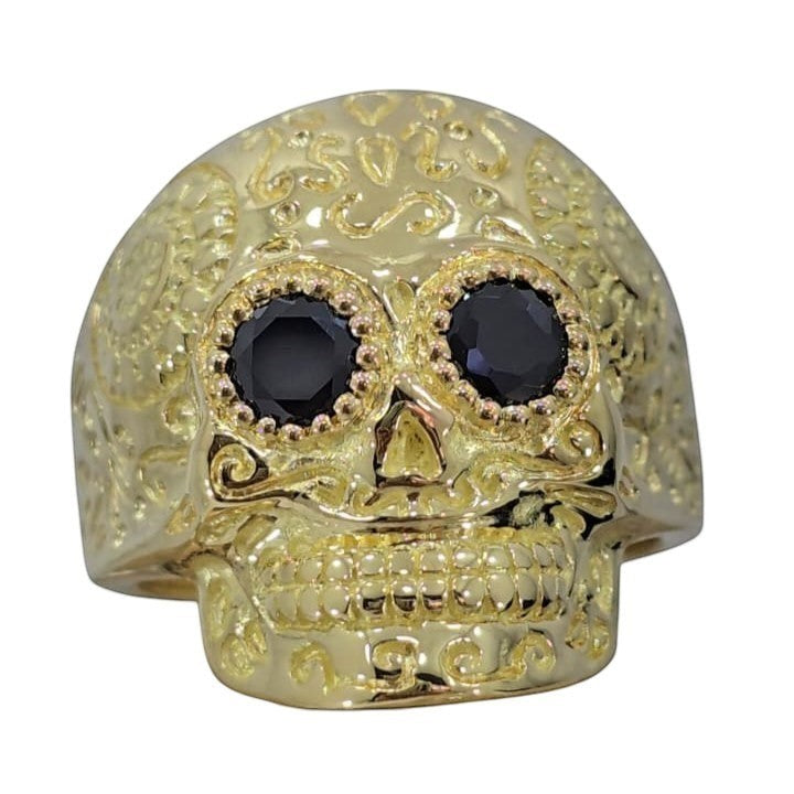 Jade18k 18k gold skull ring with black zircon eyes and intricate scrollwork details.