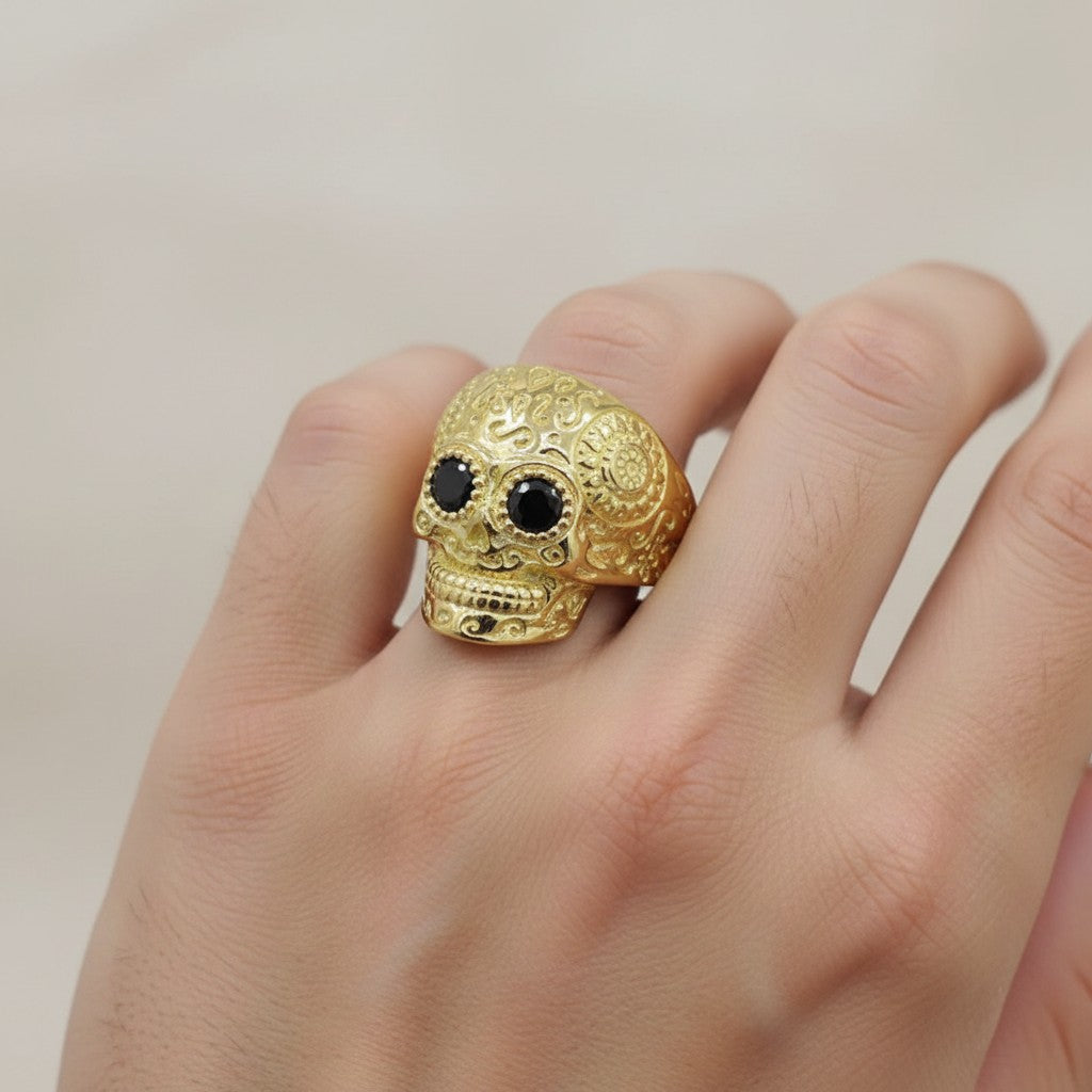 Jade18k 18k gold skull ring with black zircon eyes and ornate detailing.