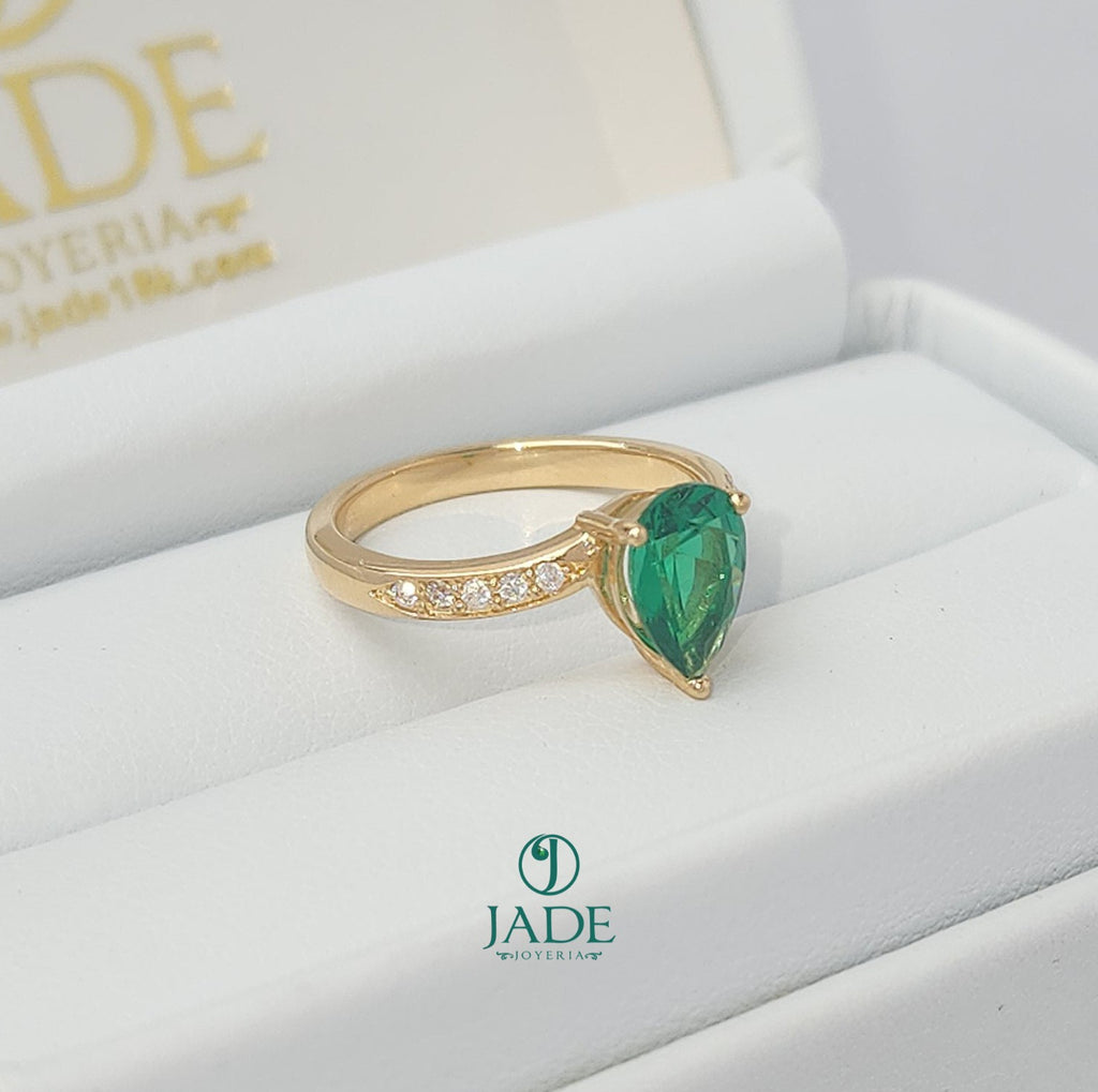 Jade18k yellow gold ring with a pear-cut green zircon center and small moissanite stones on the band.