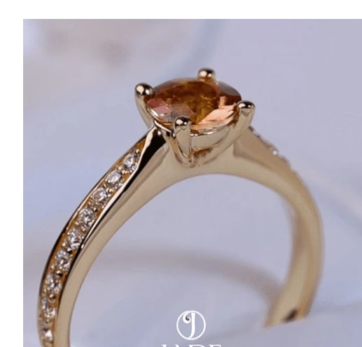 Jade18k Camille engagement ring in 18k orange gold with a 5A cubic zirconia and pavé diamonds on the band.