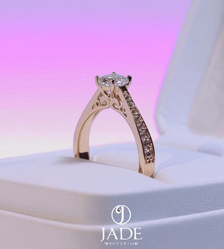 Jade18k Mariafer engagement ring in 18k orange gold with 5A cubic zirconia stones and intricate side detailing.