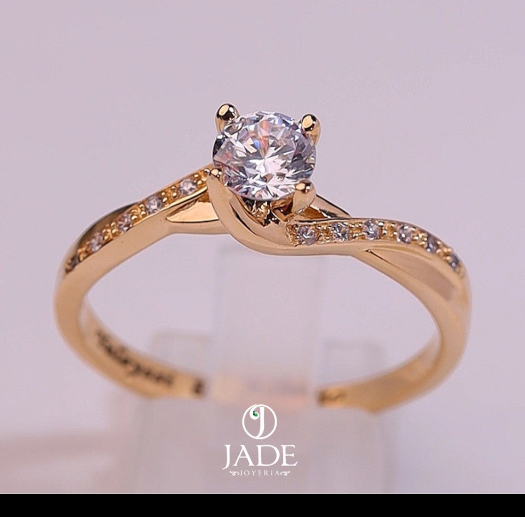 Jade18k Paulina engagement ring in 18k orange gold with a central cubic zirconia and small stones on the band.