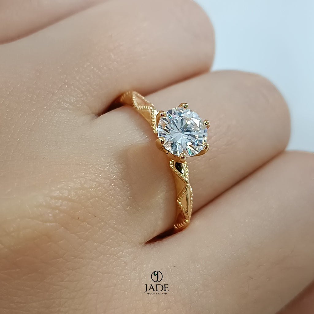 Jade18k Lucie engagement ring in 18k orange gold with a round cubic zirconia stone and intricate band detail.