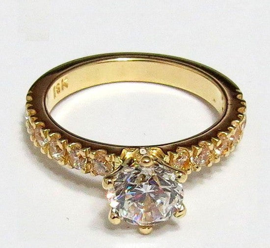 Jade18k engagement ring in 18k orange gold with a central cubic zirconia and small stones along the band.