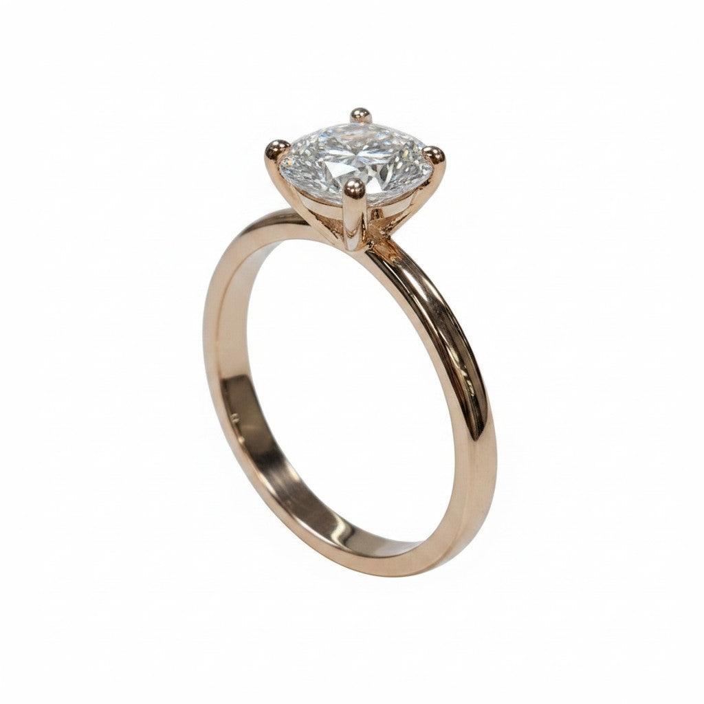 Jade18k engagement ring in 18k orange gold with a round-cut cubic zirconia stone.