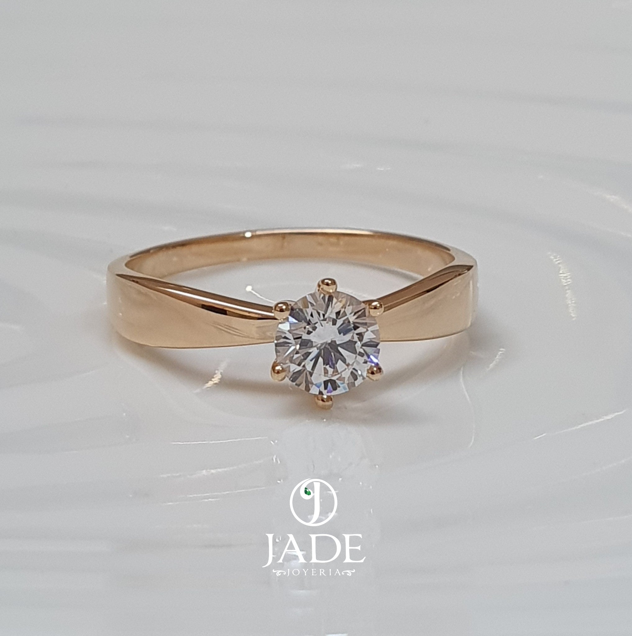 Jade18k Helena engagement ring in 18k orange gold with a round-cut cubic zirconia stone.