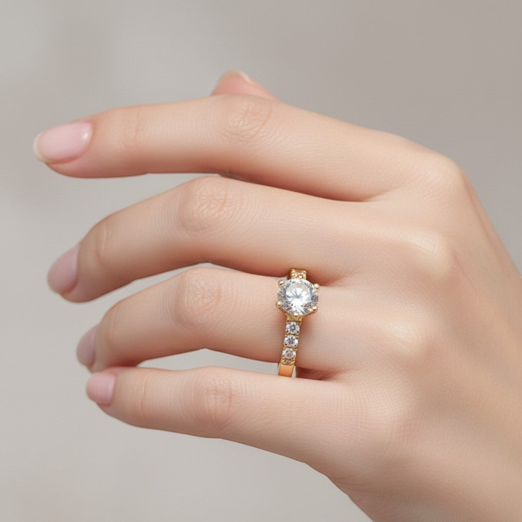 Jade18k engagement ring in orange 18k gold with a central cubic zirconia and smaller stones on the band.