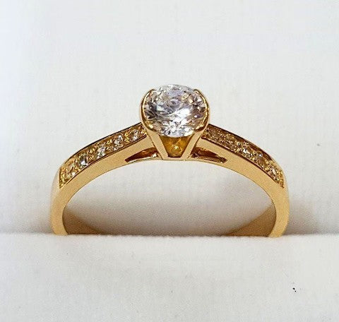 Jade18k Elemental engagement ring in 18k orange gold with a central cubic zirconia and pave stones on the band.