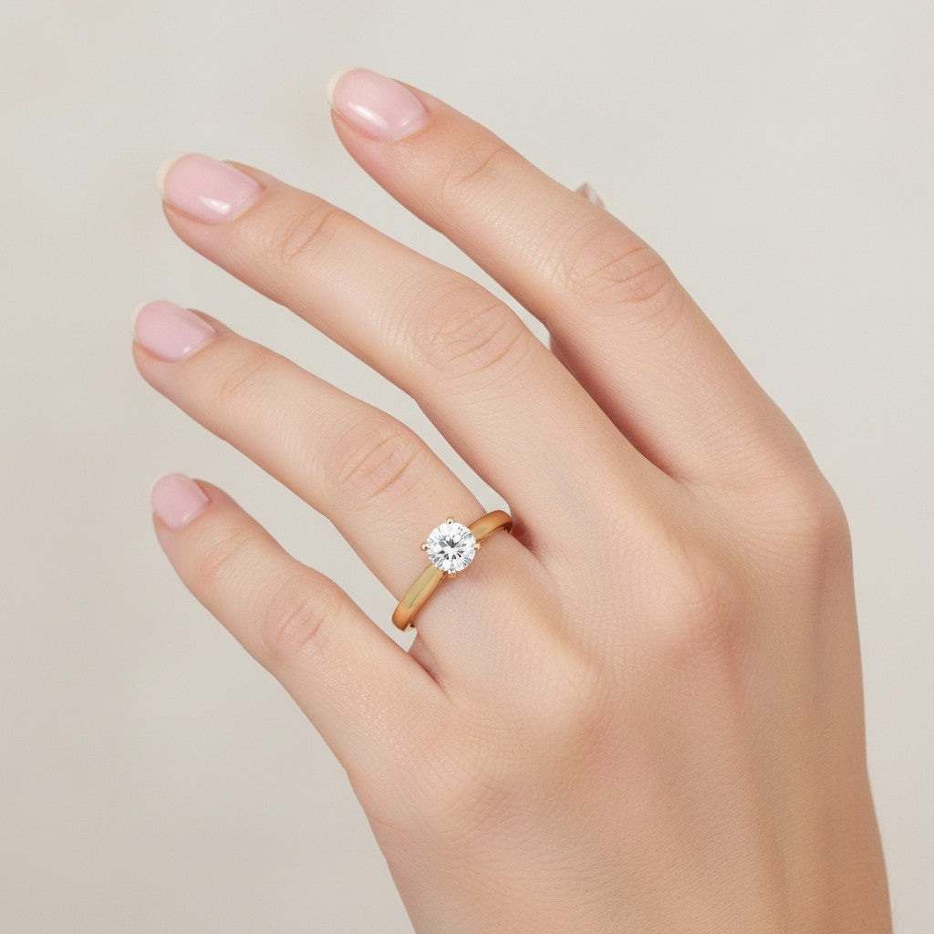 Jade18k Yesabel engagement ring in 18k orange gold with a round cubic zirconia stone and intricate filigree details on the band.