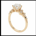 Jade18k Frisda 2 engagement ring in 18k orange gold with a central zircon stone and small accent stones on the band.