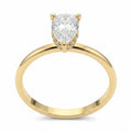Jade18k 18k orange gold engagement ring with pear-cut zircon stone and small diamonds on band.