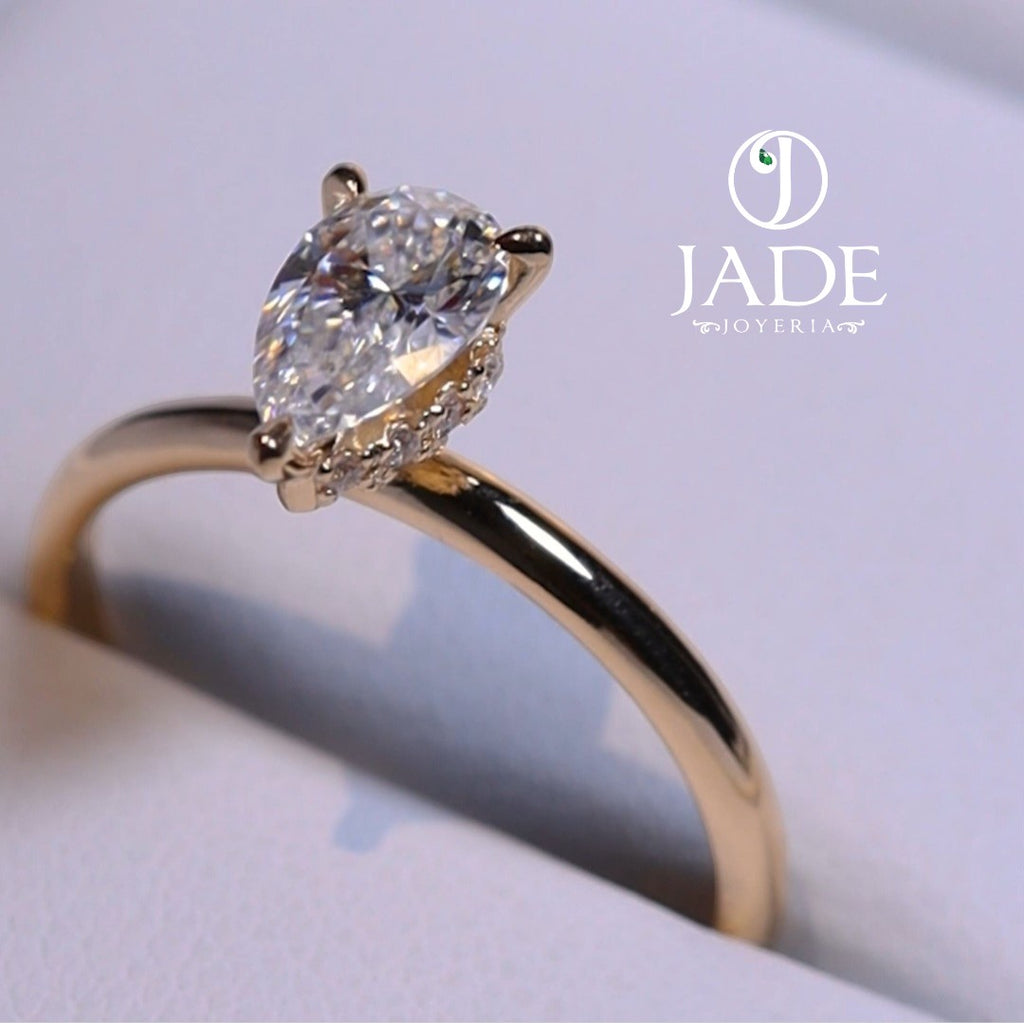 Jade18k 18k orange gold engagement ring with pear-cut zircon stone and small diamonds on band.