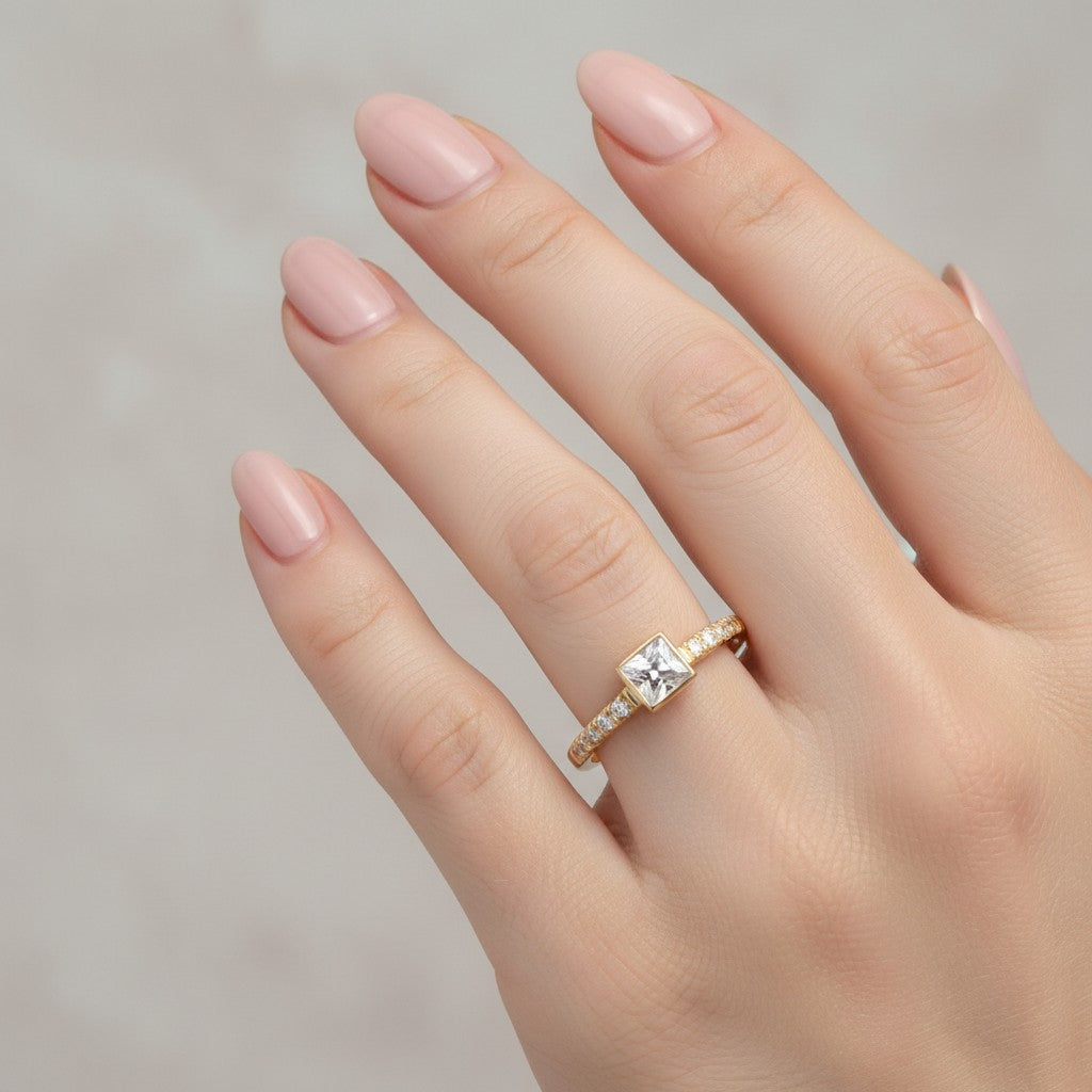Jade18k Laura engagement ring in 18k orange gold with a princess-cut cubic zirconia and small side stones.