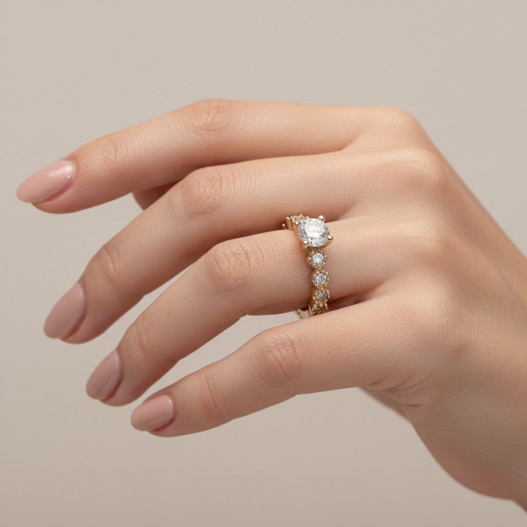 Jade18k Lians engagement ring in 18k orange gold with a central zircon stone and small stones along the band.