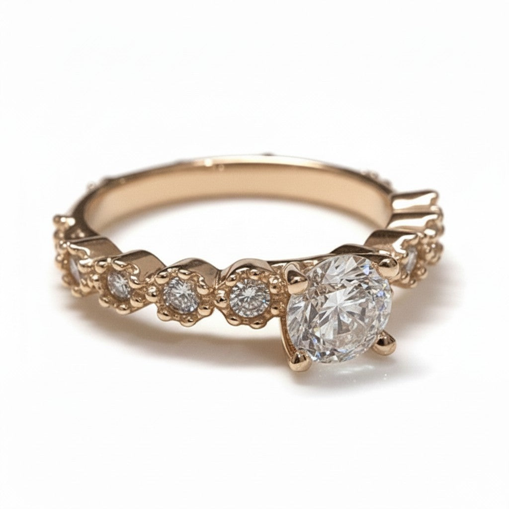 Jade18k Lians engagement ring in 18k orange gold with a central zircon stone and small stones along the band.