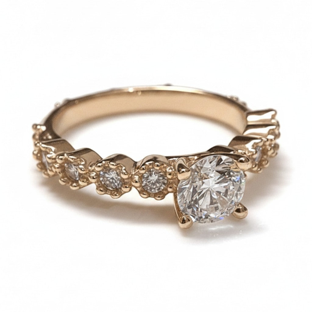 Jade18k Lians engagement ring in 18k orange gold with a central zircon stone and smaller stones along the band.
