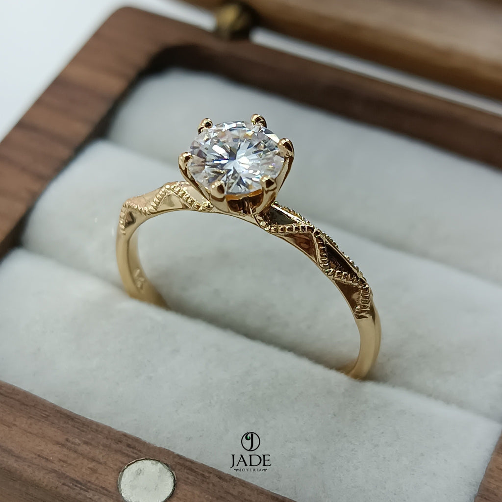 Jade18k Lucie engagement ring in 18k orange gold with a round-cut zircon stone and intricate band detailing.