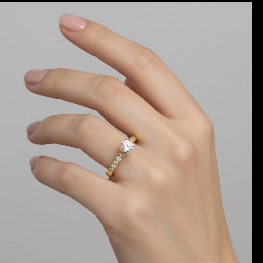 Jade18k Elemental engagement ring in 18k orange gold with a central zircon stone and smaller stones along the band.