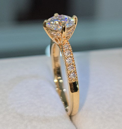 Jade18k engagement ring with moissanite center stone and pavé band in 18k orange gold.