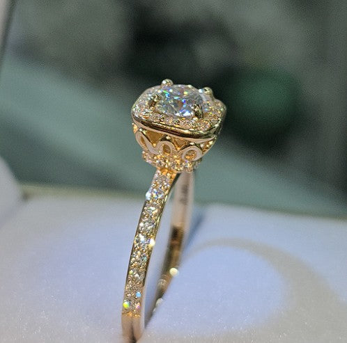 Jade18k 18k orange gold engagement ring with moissanite center stone and halo, pavé band.
