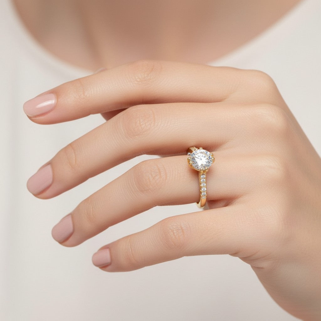 Jade18k 18k orange gold engagement ring with a large round moissanite center stone and smaller moissanite accent stones on the band.