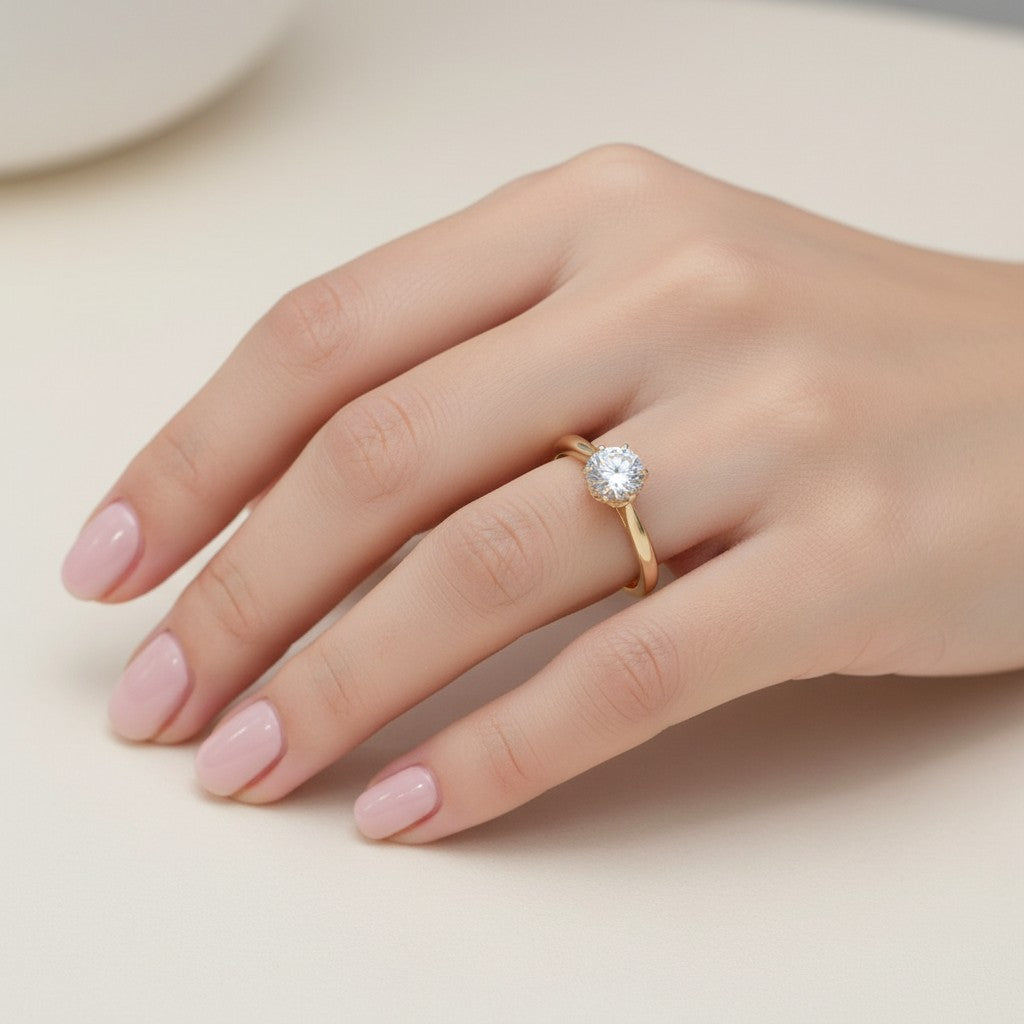 Jade18k 18k orange gold engagement ring with a round moissanite stone and a delicate band.