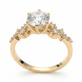 Jade18k 18k orange gold engagement ring with a large moissanite center stone and smaller accent stones on the band.