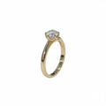 Jade18k 18k orange gold engagement ring with a moissanite center stone and a floral-inspired setting.