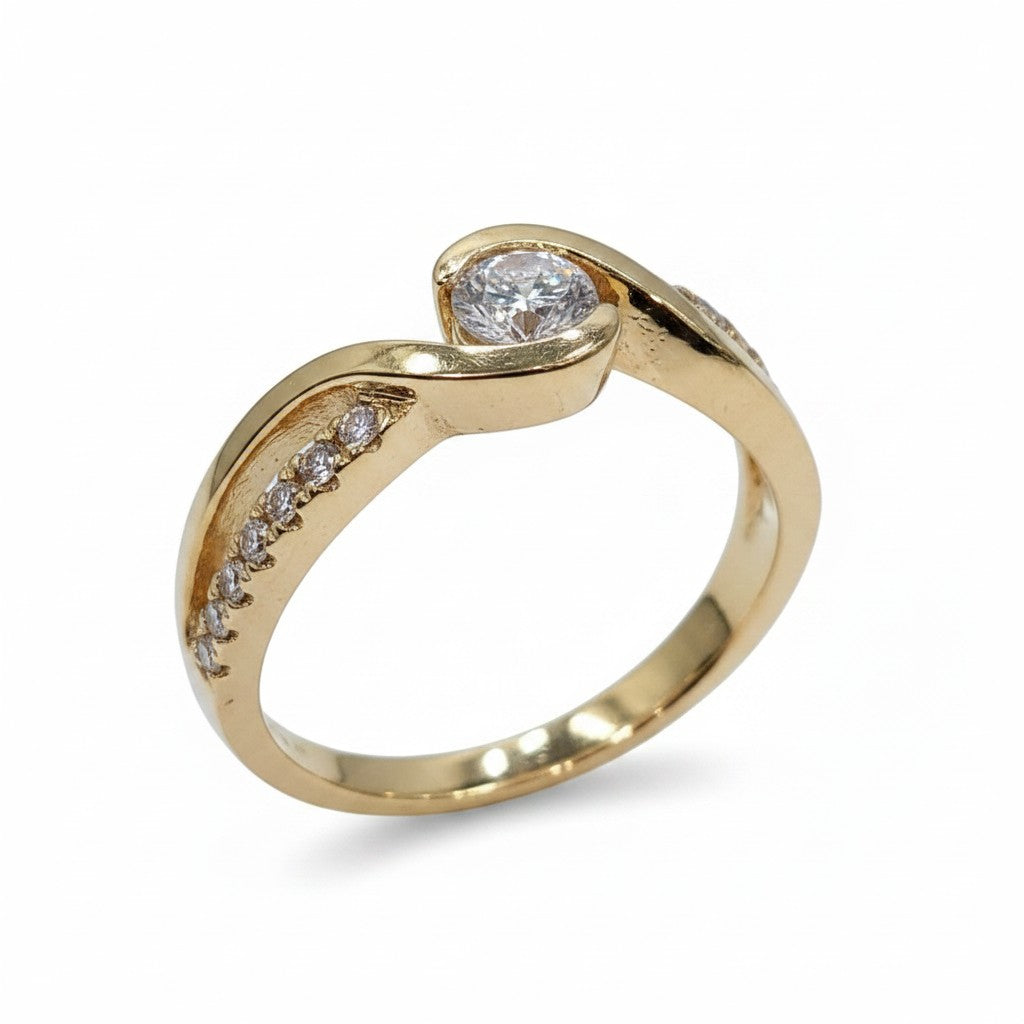 Jade18k orange gold ring with a central cubic zirconia and pavé cubic zirconia accents. Approx. 5g.