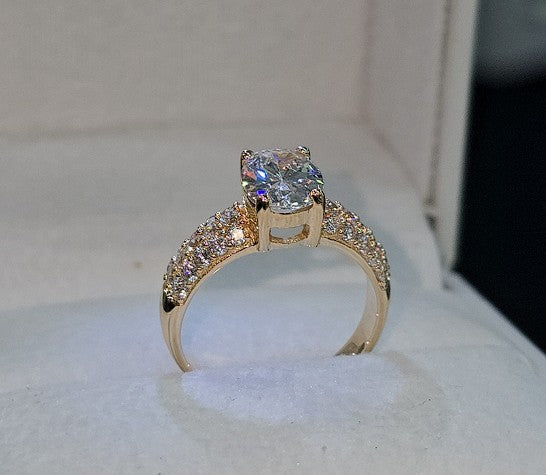 Jade18k Dominio Absoluto 18k orange gold ring with pave cubic zirconia band and oval center stone.