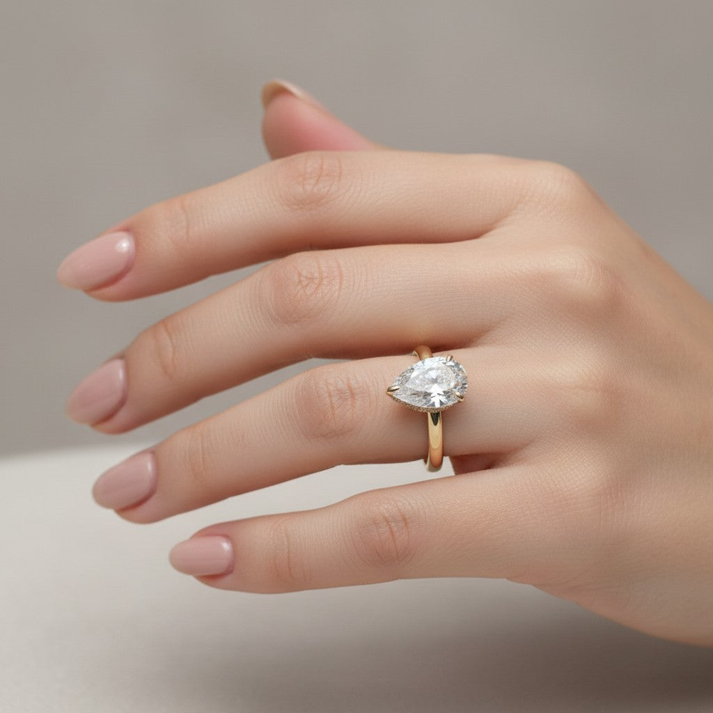 Jade18k 18k yellow gold pear cut moissanite engagement ring with pavé band.