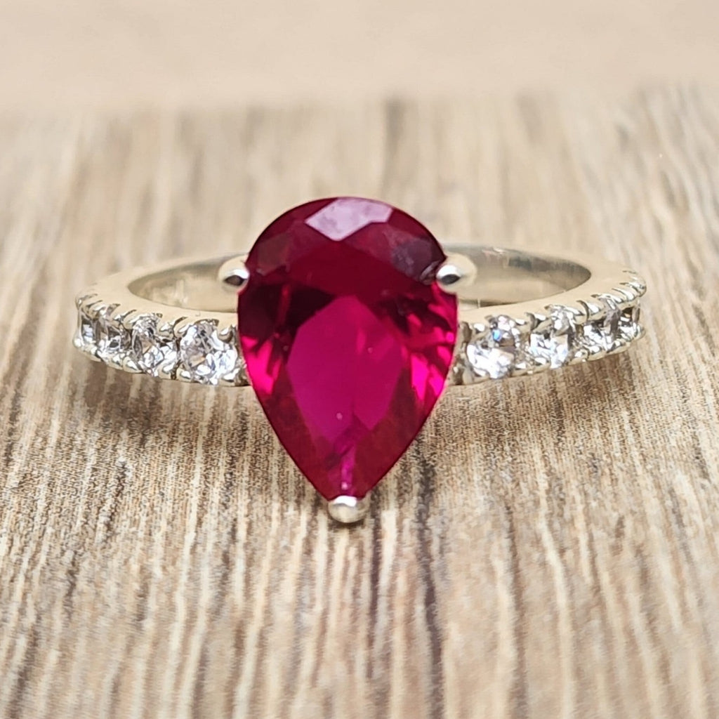 Jade18k silver ring with a pear-cut deep red gemstone and pave band. Elegant statement ring.
