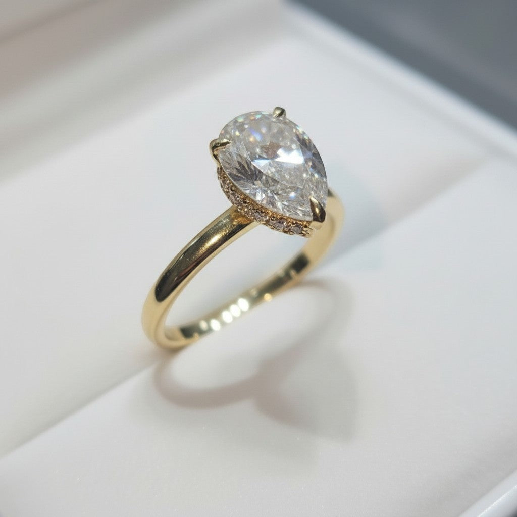 Jade18k 18k yellow gold pear-cut moissanite engagement ring with pavé band.