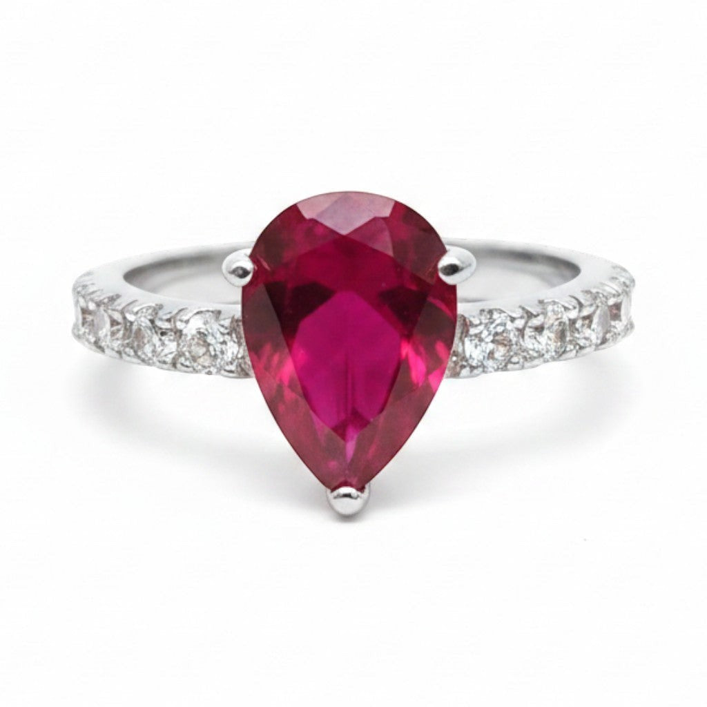 Jade18k pear-cut ruby gemstone ring with pave diamond band in silver. Elegant statement ring.
