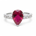 Jade18k pear-cut ruby gemstone ring with pave diamond band in silver. Elegant statement ring.