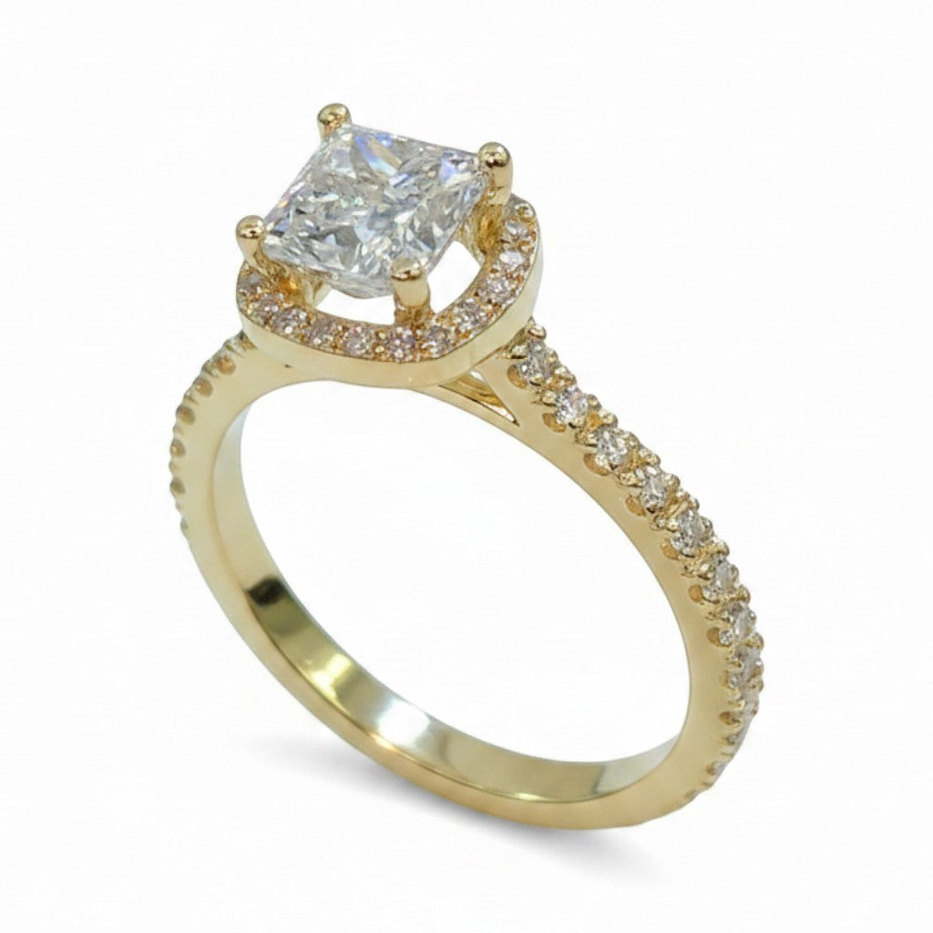 Jade18k 18k yellow gold princess cut diamond engagement ring with a halo of smaller stones and pavé band.