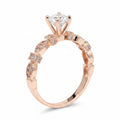 Jade18k Queen engagement ring with moissanite center stone and intricate rose gold band with small diamonds.