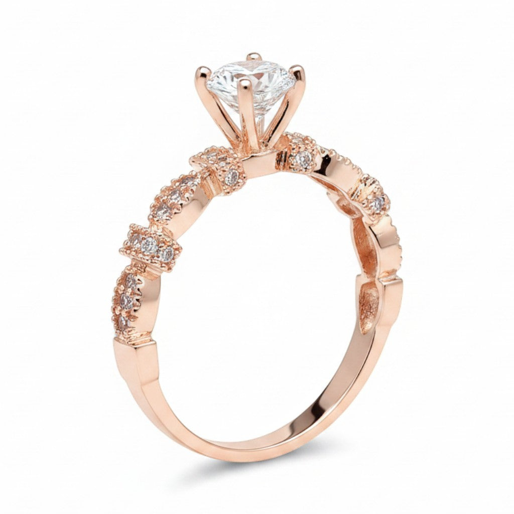 Jade18k Queen engagement ring with moissanite center stone and intricate rose gold band with small diamonds.