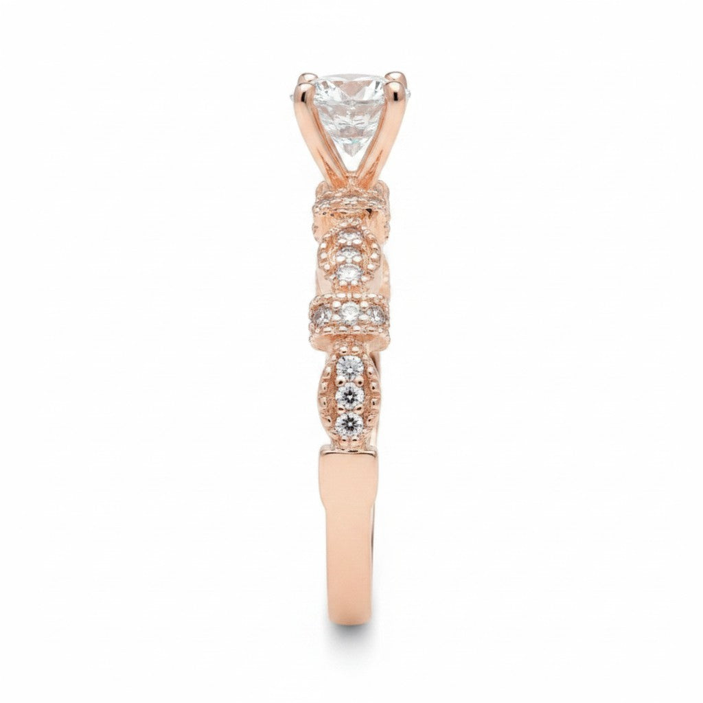 Jade18k Queen engagement ring with moissanite center stone and rose gold band with diamond accents.