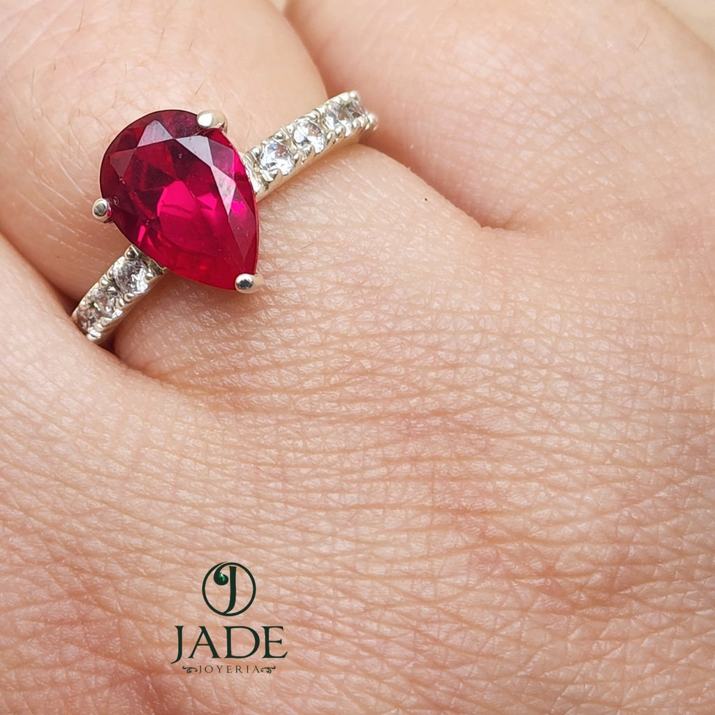 Jade18k Gota de Pasión ring with a large pear-shaped ruby and small diamonds on a fine silver band.