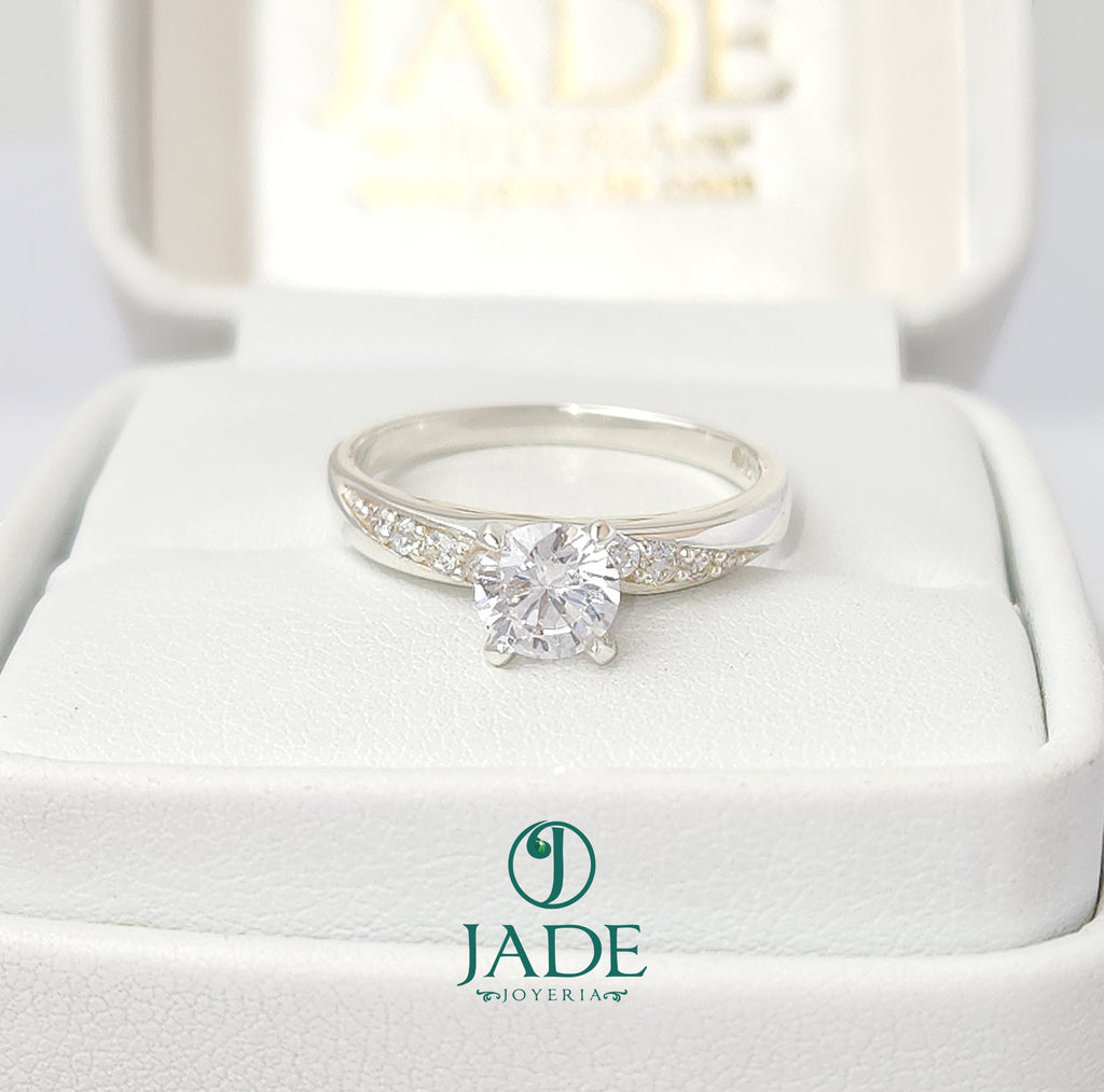 Jade18k April engagement ring in sterling silver with a central round-cut cubic zirconia and pavé accents.