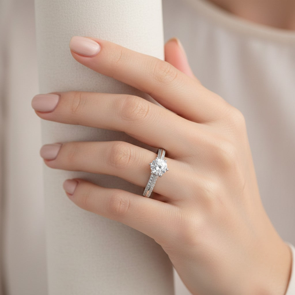 Jade18k engagement ring with a central round-cut cubic zirconia and a band lined with small cubic zirconia stones, crafted from silver.