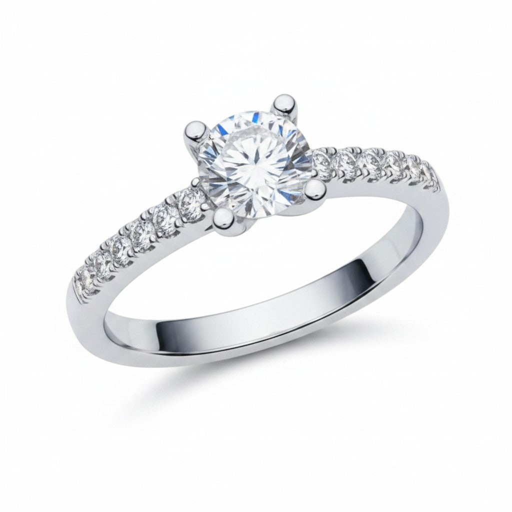 Jade18k Rafaella engagement ring with a round-cut diamond and pavé band in silver.